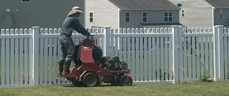 Lawn employee mowing a back yard in Huntersville, NC.