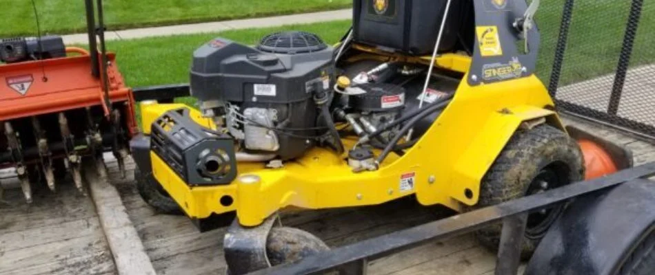 Red and yellow aerator machines on a trailer in Charlotte, NC.